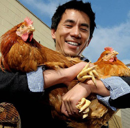 Founder Dennis Mao holding chickens