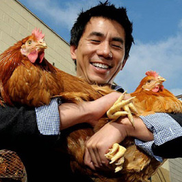 Founder Dennis Mao holding chickens